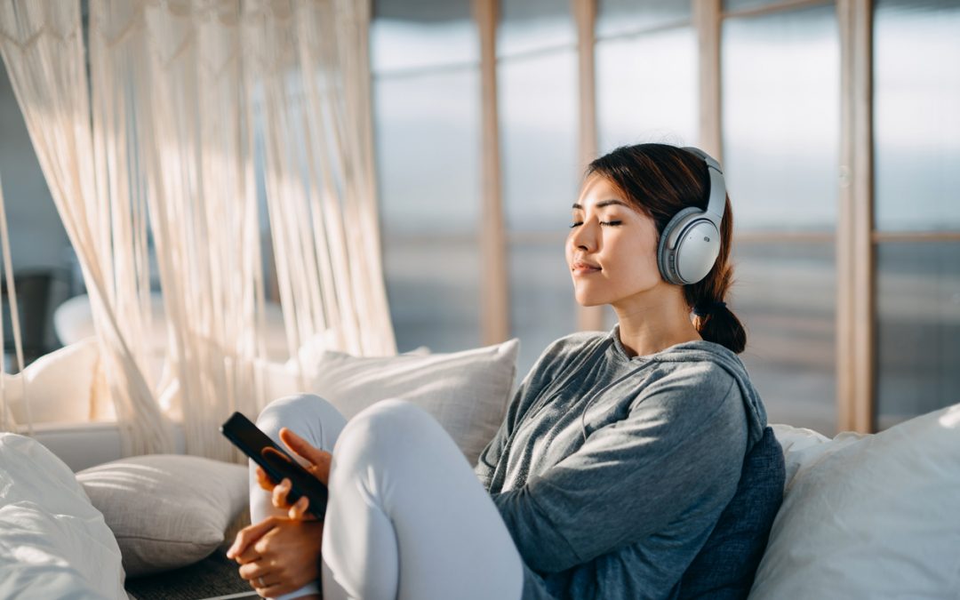 young Asian woman taking a mental health break by listening to music